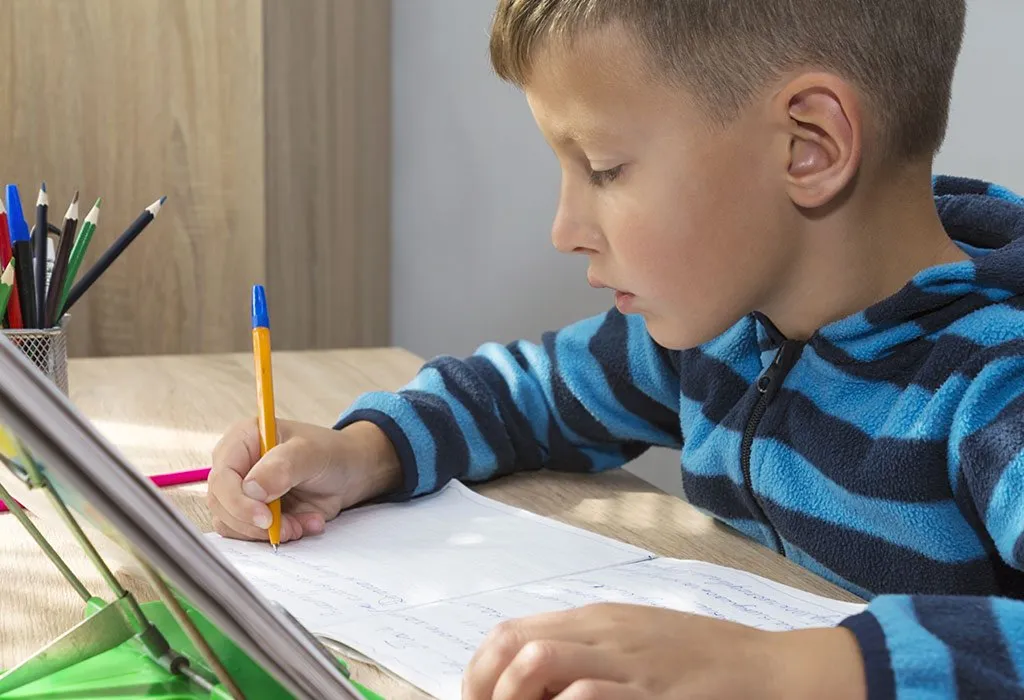 A boy practices cursive writing