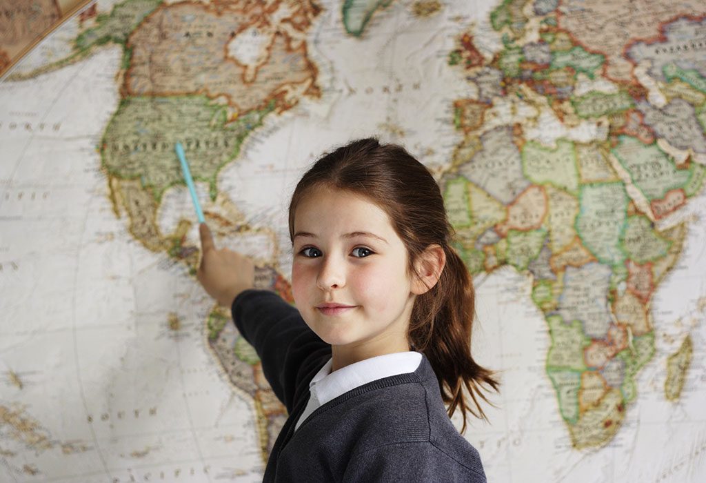 Girl identifying places on world map