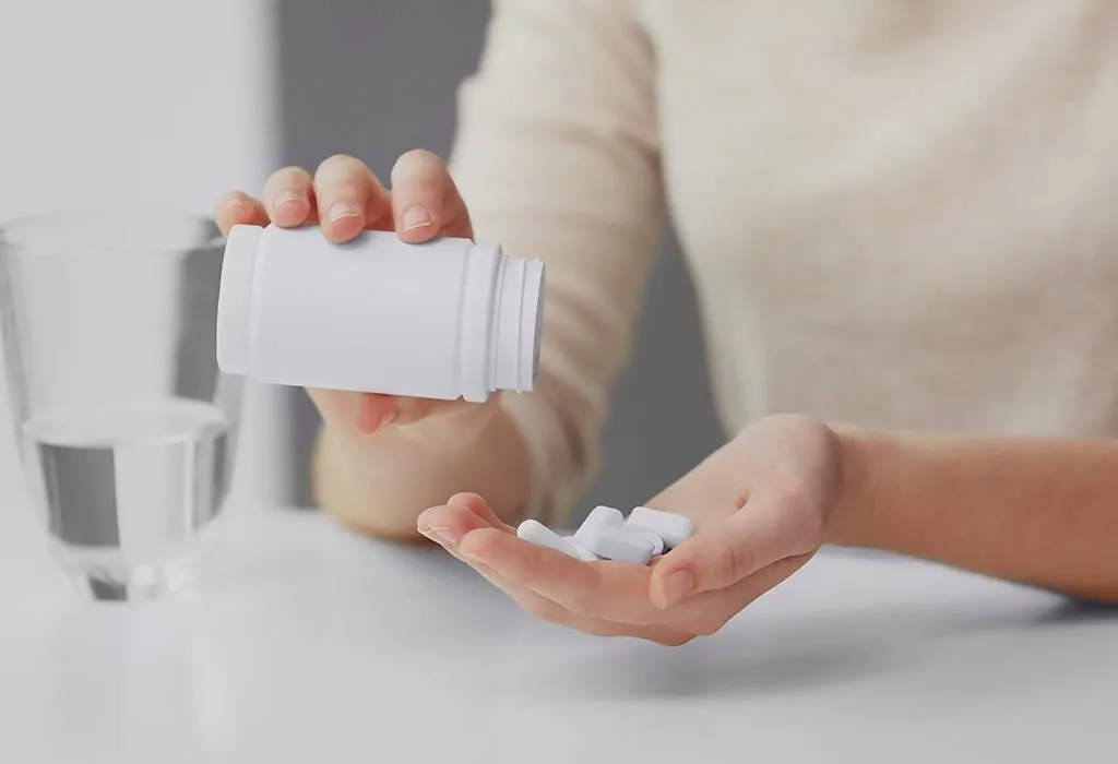 Woman about to take manganese supplement