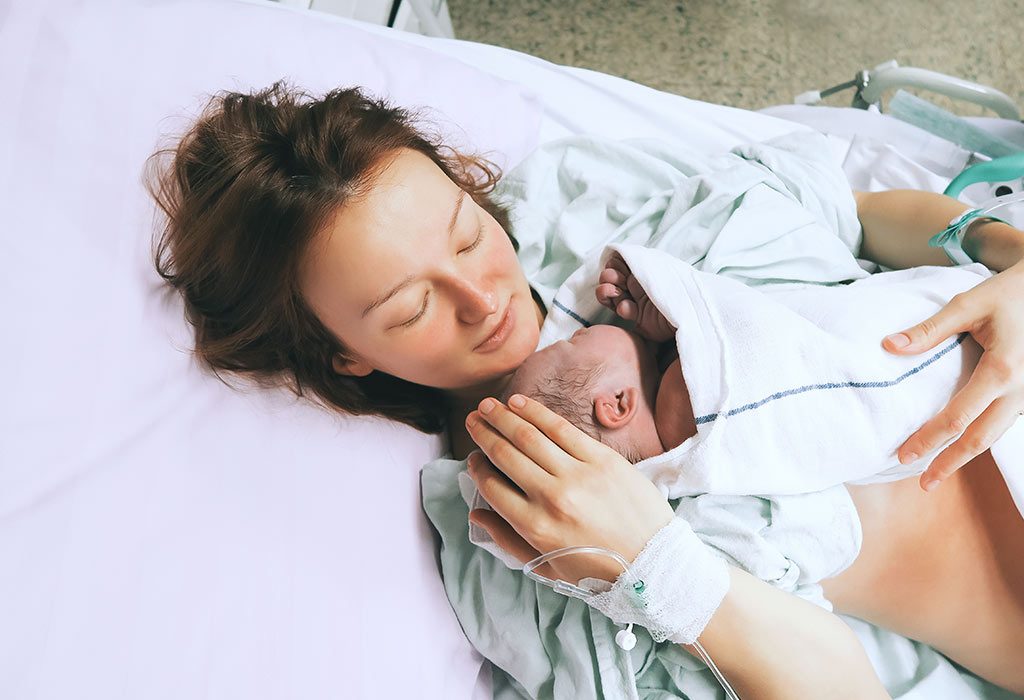 A mother holding her newborn in her arms in the hospital