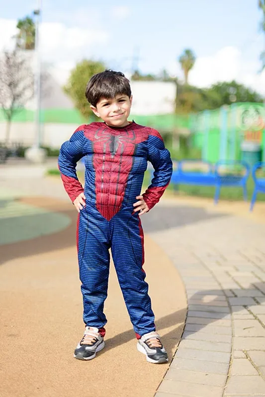 A kid wearing spiderman costume