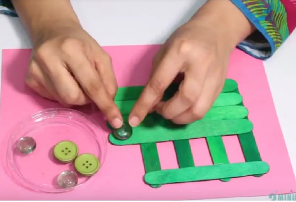 Glue the buttons/crystals on the sticks to decorate the bus.