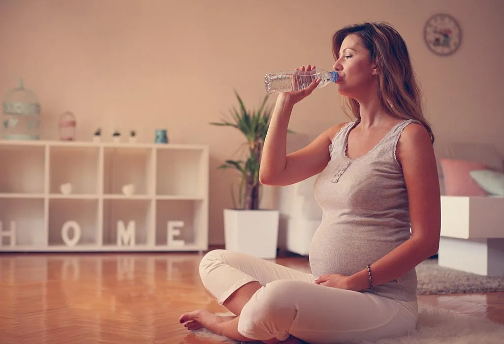 Pregnant woman drinking water Pregnant woman drinking water