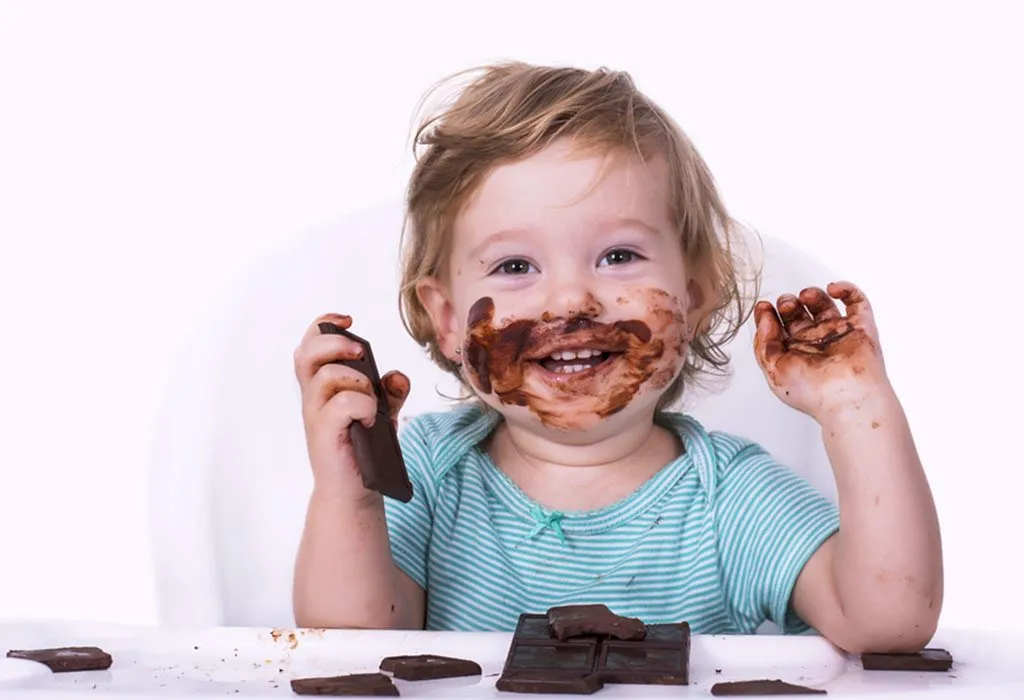 baby eating chocolate cake