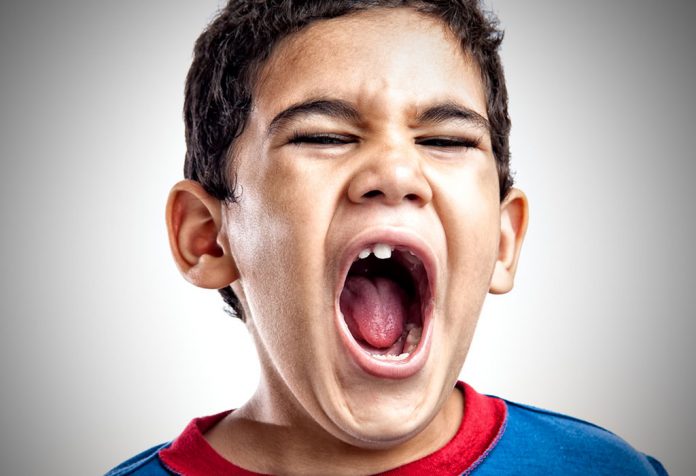 A little boy screaming with anger