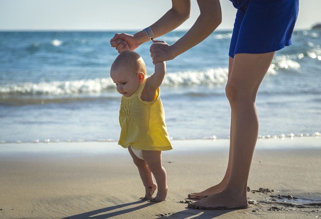 8 month old baby stands on tiptoes