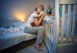 A mother comforting her baby at night