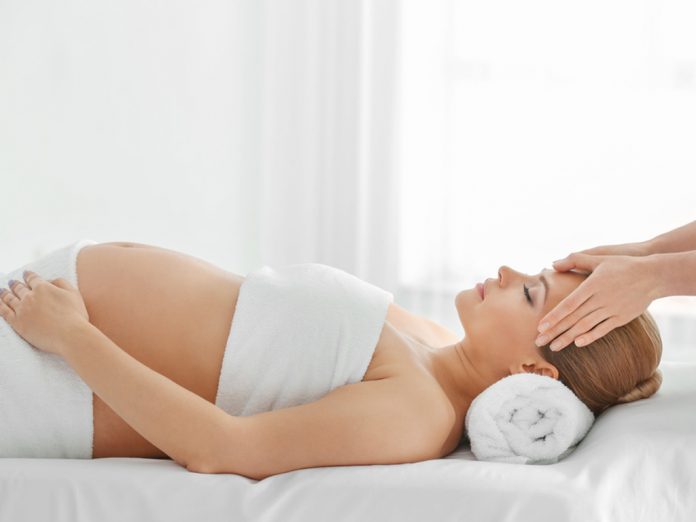 Pregnant woman getting massaged