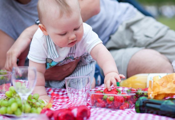 Boy taking fruits on his own