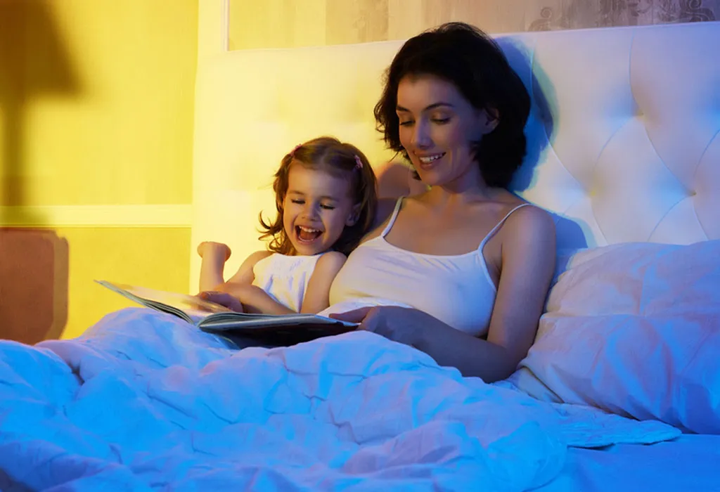 A mom reading a book to her daughter