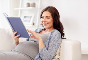 A pregnant woman reading a book