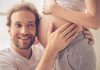 गर्भावस्था के दौरान करें यह 10 फन एक्टिविटीज A man listening to his unborn baby's sounds, while resting his head near his wife's belly