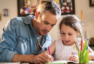 Father helping child with homework