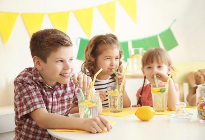 Three kids sipping on lemonade