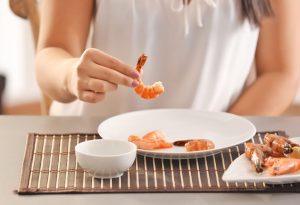 A woman consuming shrimp