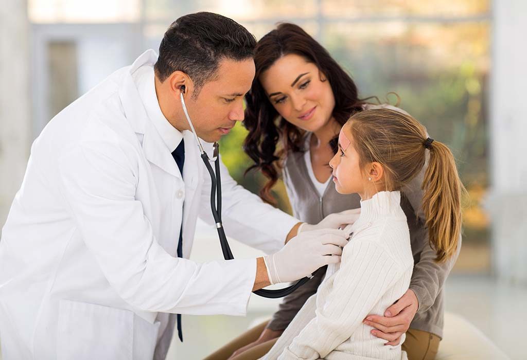Paediatrician treating child