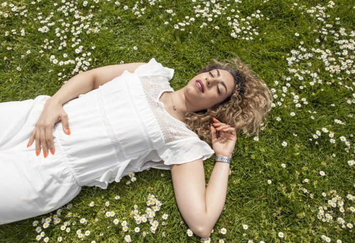 A young woman lying in the field