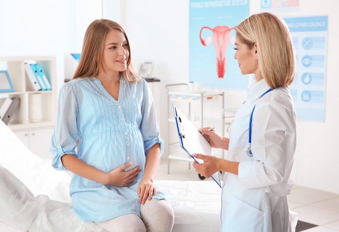 A pregnant woman talking to her gynaecologist