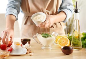 A woman preparing mayonnaise in the kitchen