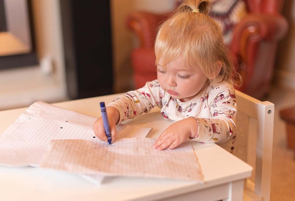 16-month-old baby scribbling on a piece of paper