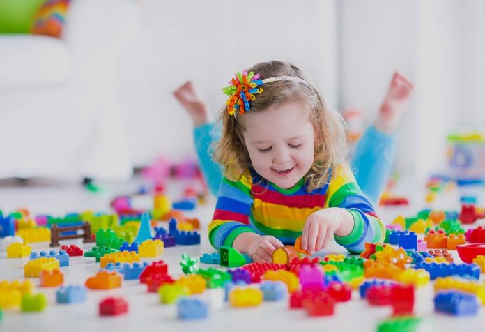 Preschooler playing with colourful blocks