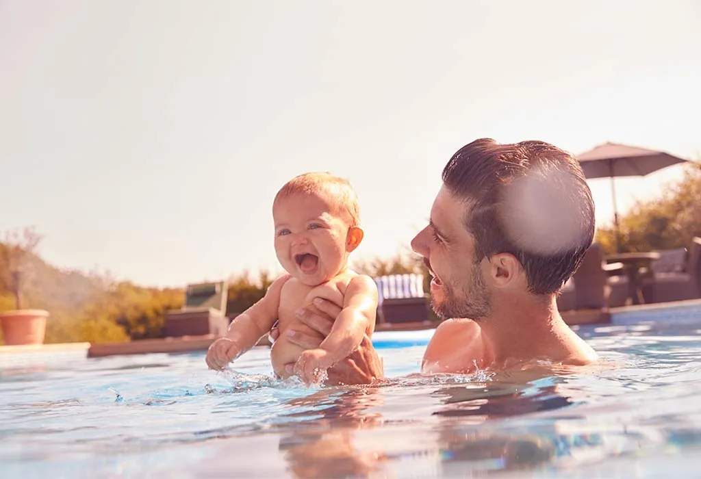 Baby playing in swimming pool