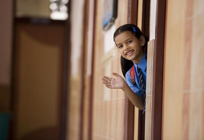 A little girl dressed in her school uniform
