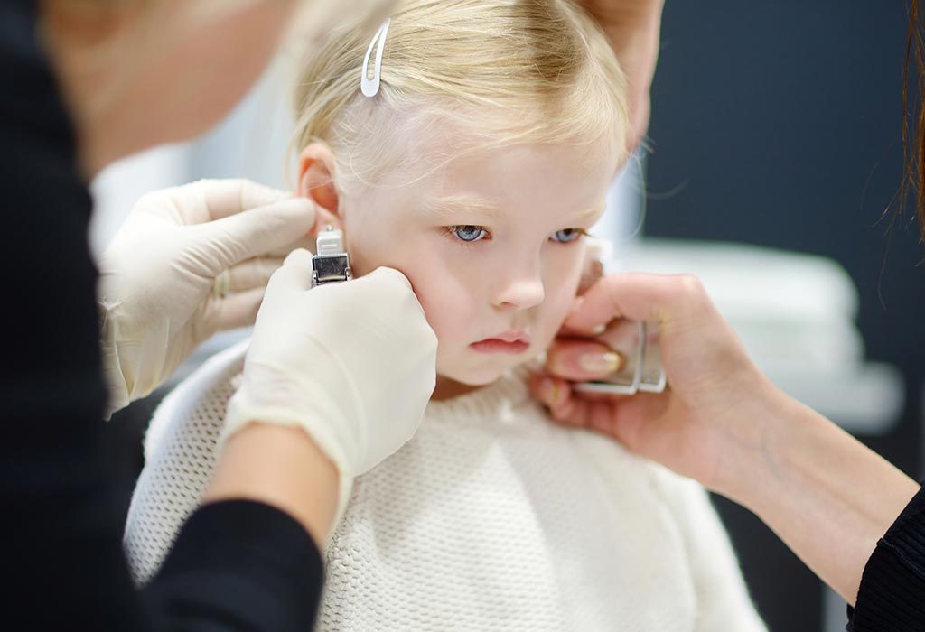 Girl getting ear pierced