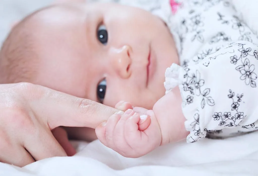 baby holding finger