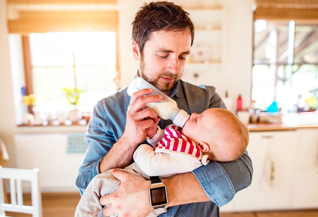 FATHER FEEDING BABY