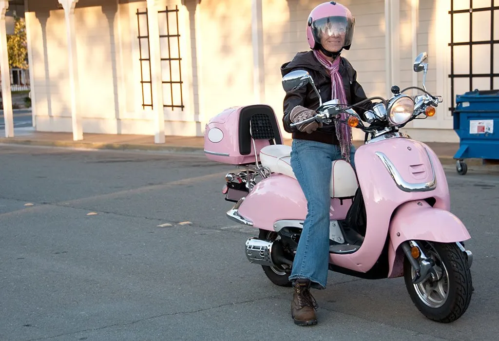 A woman wearing a helmet while riding a bike