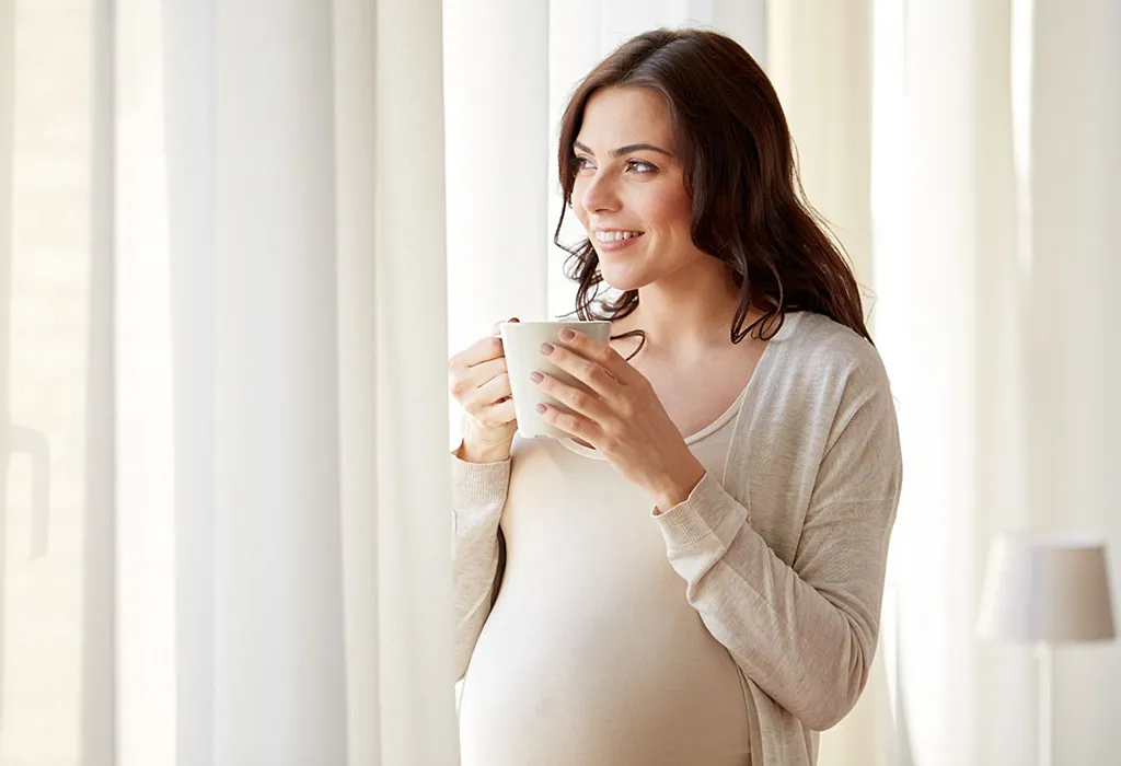 Pregnant woman drinking decaf black tea Pregnant woman drinking decaf black tea
