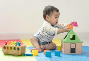 A baby boy playing with toys