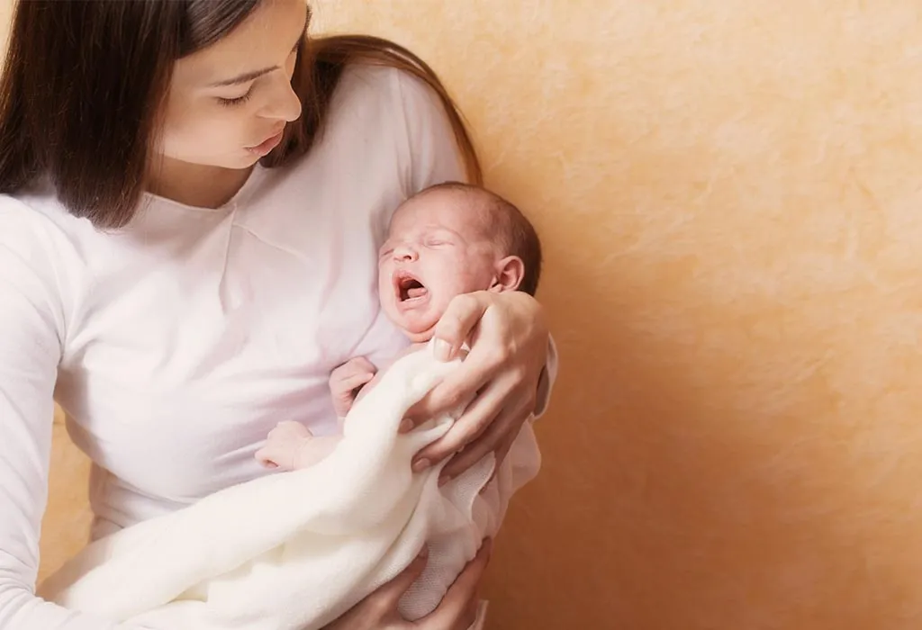 A mother trying to put her infant to sleep