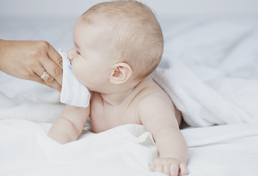 A mother wiping her baby's mouth