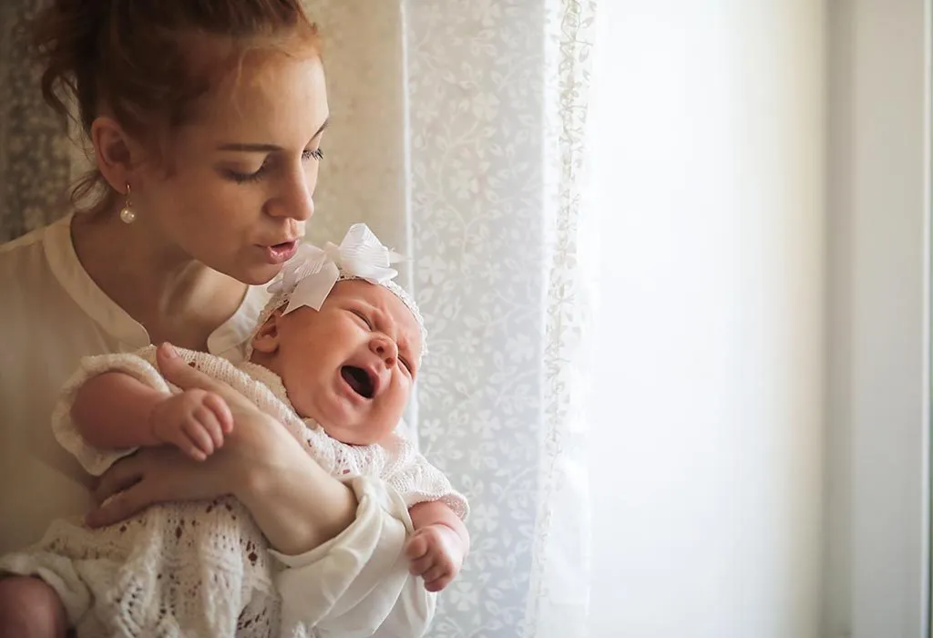 A mother holding her baby in arms