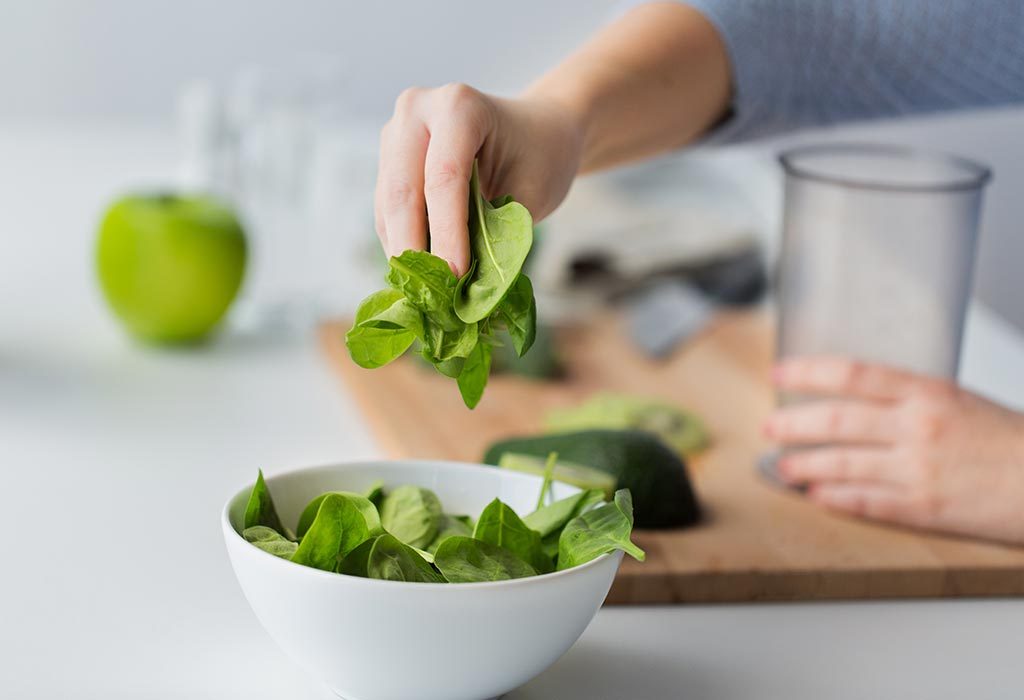 Woman making spinach smoothie