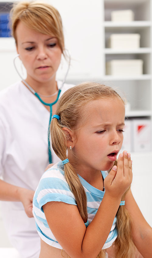 A doctor checking a little girl