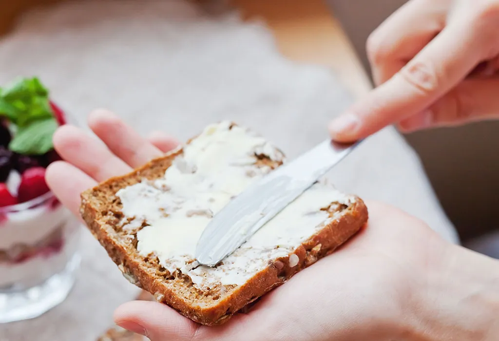 Woman buttering toast Woman buttering toast