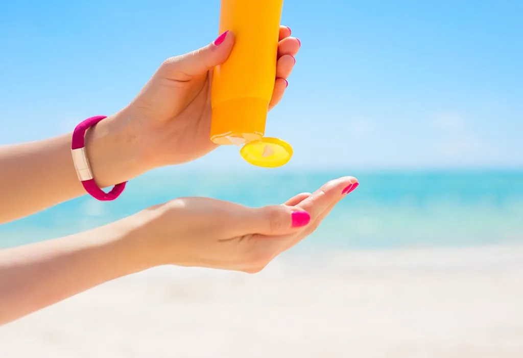 A woman using a sunscreen