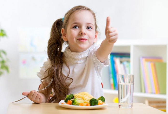A little girl enjoying her meal