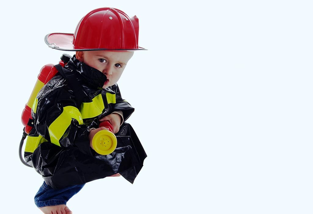 A toddler in a fire fighter's costume