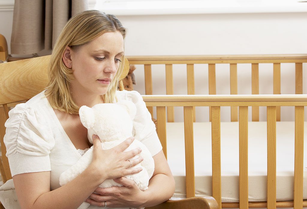 A woman with empty crib