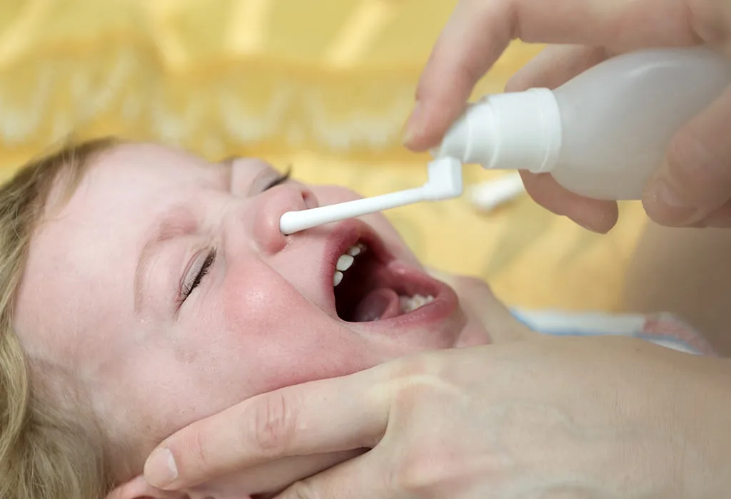 Giving saline store drops to newborn