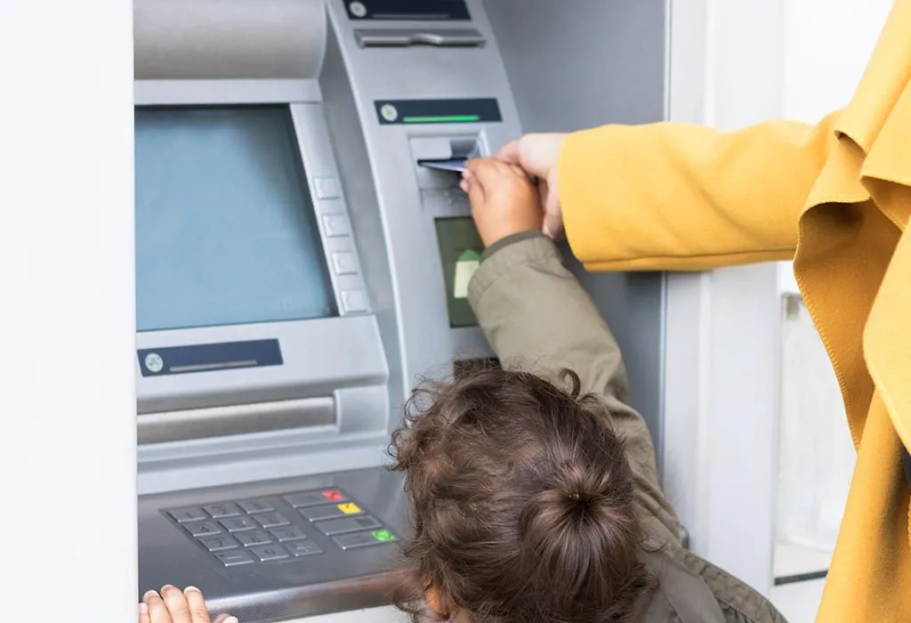 Little girl at the ATM