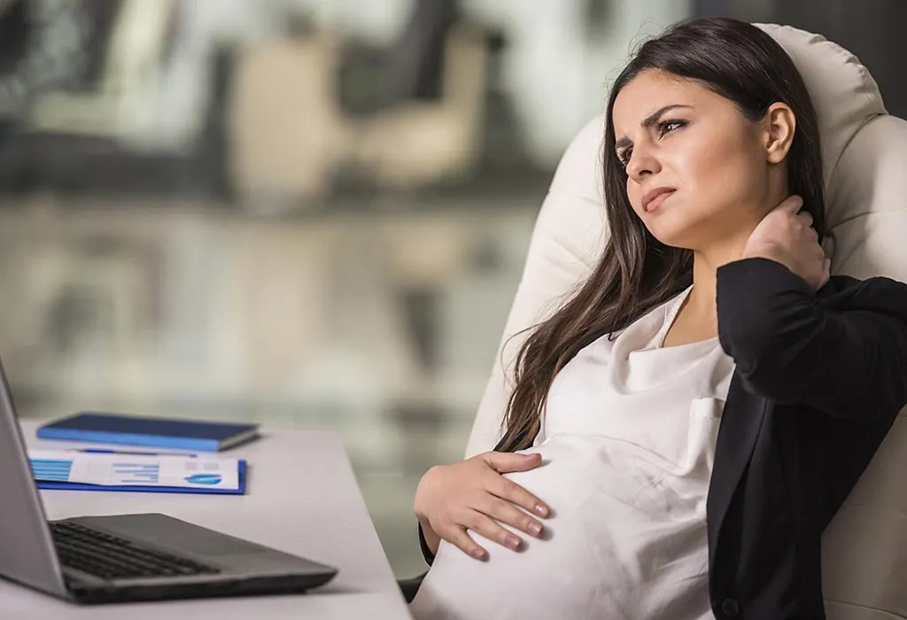 Pregnant lady having neck pain while working Pregnant lady having neck pain while working