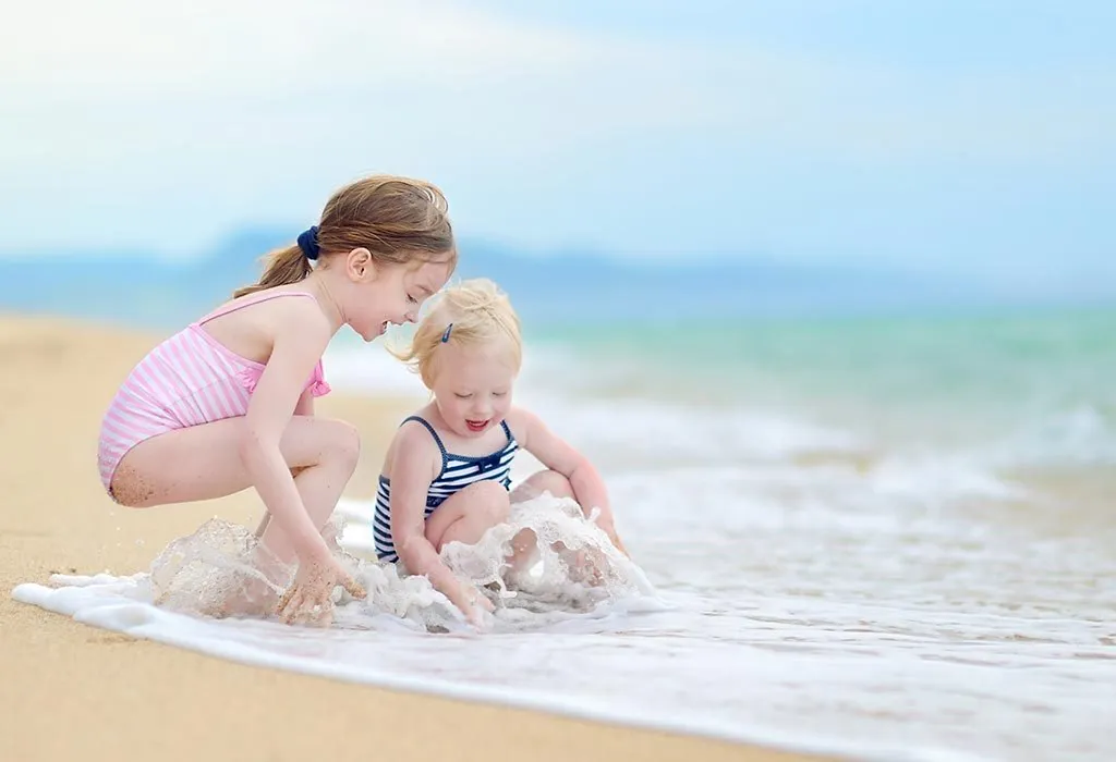 Baby girls enjoying the sea