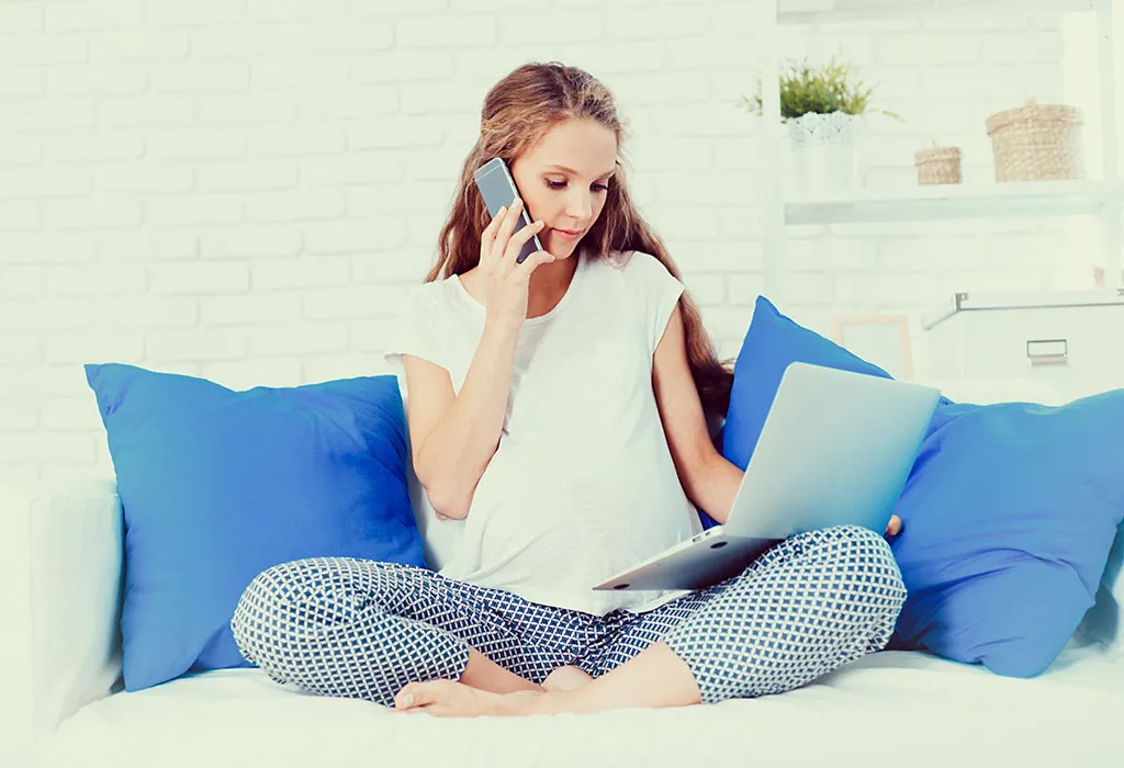 A pregnant woman works from home