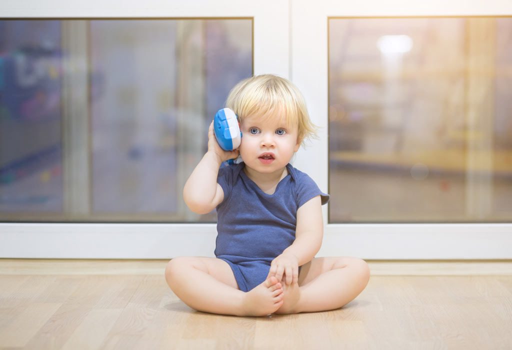 Child playing with a toy telephone