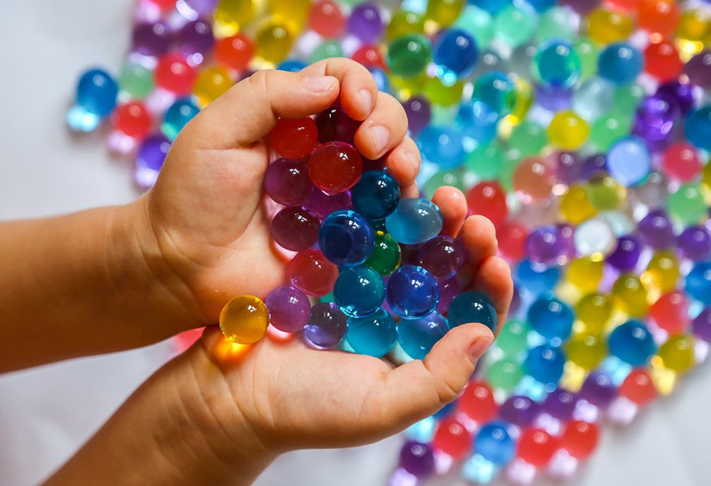 Child playing with water beads